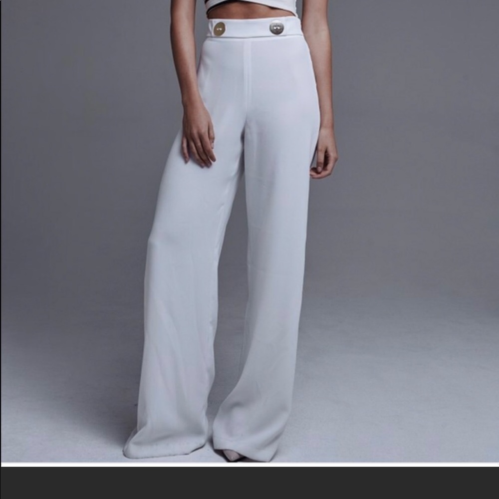 White wide leg trousers with two gold buttons